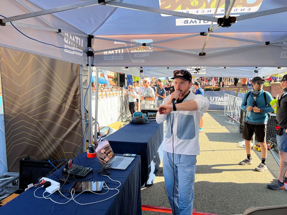 Announcing at the start line under a UTMB tent